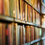 Close-up view of library shelves filled with books, ideal for concepts of education and literature.